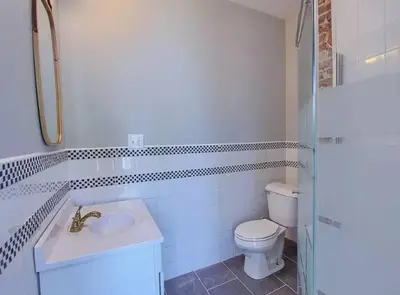 a white bathroom with a toilet and a sink at Breath of Fresh Air - House- 3 BR 2BA in Columbus