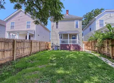 a home with a wooden fence in a yard at Breath of Fresh Air - House- 3 BR 2BA in Columbus