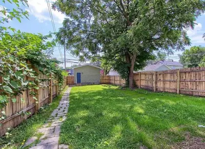 a yard with a fence and a tree at Breath of Fresh Air - House- 3 BR 2BA in Columbus