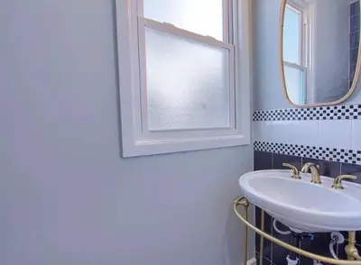 a bathroom with a sink and a window at Breath of Fresh Air - House- 3 BR 2BA in Columbus