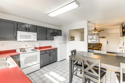 a kitchen with white appliances and a table with chairs at Quiet Dry Ridge Home with Yard - Near Ark Encounter! in Dry Ridge