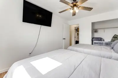 a bedroom with two beds and a flat screen tv at Quiet Dry Ridge Home with Yard - Near Ark Encounter! in Dry Ridge