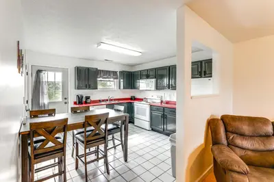 a kitchen with green cabinets and a table and chairs at Quiet Dry Ridge Home with Yard - Near Ark Encounter! in Dry Ridge
