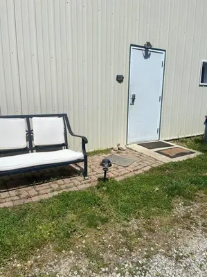 a bench sitting in front of a door at 102 Acre Pet Friendly Horse Farm! Bring your horse too! in Lebanon