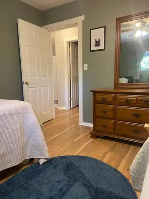 a bedroom with a bed and a dresser and a mirror at 102 Acre Pet Friendly Horse Farm! Bring your horse too! in Lebanon