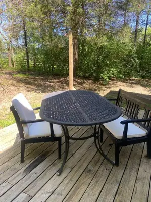 a black table and two chairs on a deck at 102 Acre Pet Friendly Horse Farm! Bring your horse too! in Lebanon