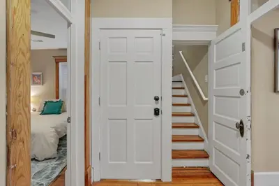a white door leading to a bedroom with a bed at The Goodale House - 2 Units - 4 BR 5 Bath in Columbus