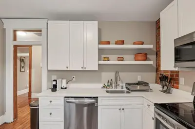 a kitchen with white cabinets and a sink at The Goodale Overlook in Columbus