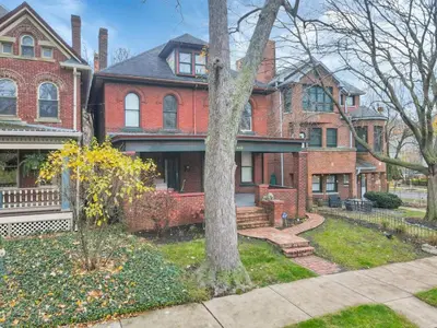 a red brick house with a tree in the yard at The Goodale Overlook in Columbus