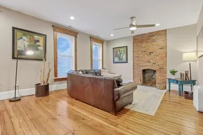 a living room with a couch and a fireplace at The Goodale Overlook in Columbus