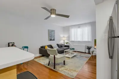 a living room with a couch and a ceiling fan at Cozy 2 BR in Short North Convenient Parking in Columbus