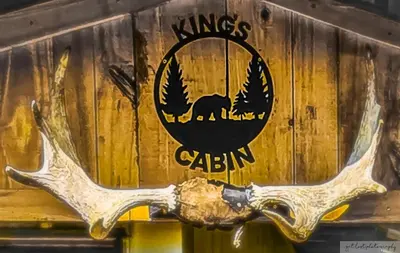 a sign on the side of a train with a moose antlers at Cabin with Character in New Lexington