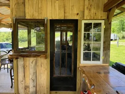 a wooden cabin with a door and windows on it at Cabin with Character in New Lexington