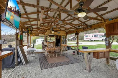 an outside view of an rv with a table and chairs at Cabin with Character in New Lexington