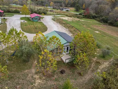an aerial view of a small house in a field at Cabin with Character in New Lexington