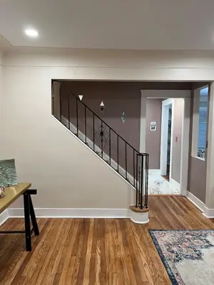 a staircase in a living room with a wooden floor at Sunny Lavender Canopy Retreat in Cleveland