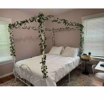 a bedroom with a bed with a ivy frame at Garden Whisper Cozy Chamber in Cleveland