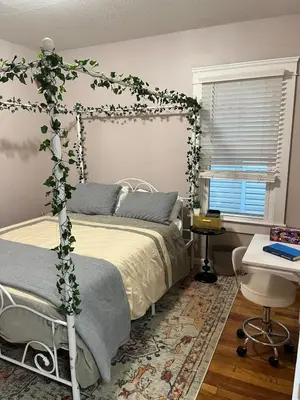 a bedroom with a bed with ivy on it at Garden Whisper Cozy Chamber in Cleveland