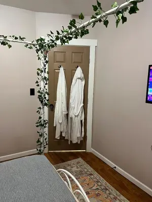 a room with a door with white clothes at Garden Whisper Cozy Chamber in Cleveland