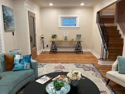 a living room with a couch and a table at Garden Whisper Cozy Chamber in Cleveland