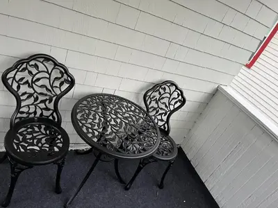 two chairs and a table sitting next to a wall at Stained Glass Serenity Suite in Cleveland