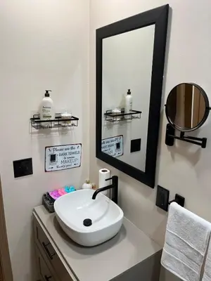 a bathroom with a white sink and a mirror at Stained Glass Serenity Suite in Cleveland