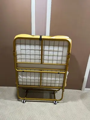 a yellow shopping cart in the corner of a room at Elevated Entertainment Sleep Suite in Cleveland