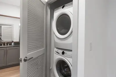 a laundry room with a washer and dryer at 3 Stylish apartments near shops and entertainment in Cincinnati