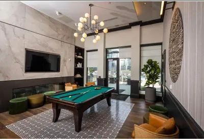 a living room with a pool table and a tv at 3 Stylish apartments near shops and entertainment in Cincinnati