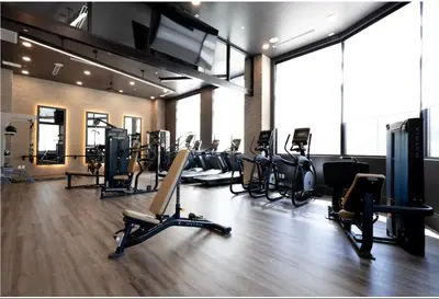 a gym with a bunch of treadms and ellipticals at 3 Stylish apartments near shops and entertainment in Cincinnati