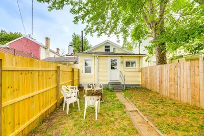 a backyard with a wooden fence and chairs at Dog-Friendly Dayton Home 1 Mi to Downtown! in Dayton