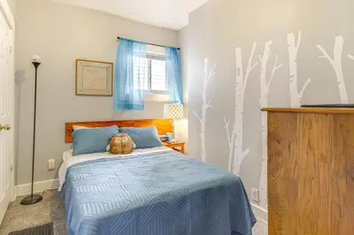 a bedroom with a bed with a cat laying on it at Dog-Friendly Dayton Home 1 Mi to Downtown! in Dayton
