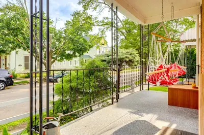a swing on the porch of a house at Dog-Friendly Dayton Home 1 Mi to Downtown! in Dayton