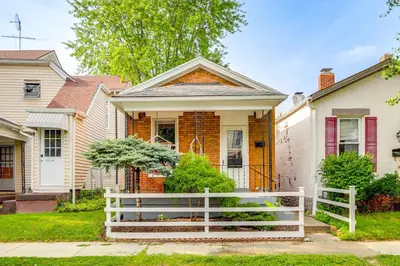 a house with a white fence in front of it at Dog-Friendly Dayton Home 1 Mi to Downtown! in Dayton
