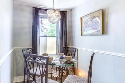 a dining room with a table and chairs and a chandelier at Dog-Friendly Dayton Home 1 Mi to Downtown! in Dayton