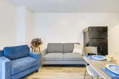a living room with a couch and a table at Walkable Barberton Apartment 9 Mi to Akron! in Barberton