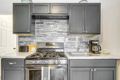 a kitchen with a stove and a sink at Walkable Barberton Apartment 9 Mi to Akron! in Barberton