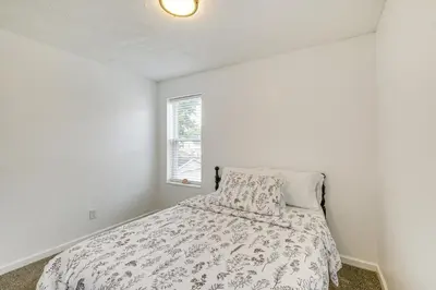 a bedroom with a bed and a window at Walkable Barberton Apartment 9 Mi to Akron! in Barberton