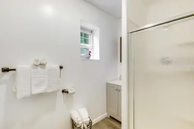 a bathroom with a shower with a glass door at Walkable Barberton Apartment 9 Mi to Akron! in Barberton