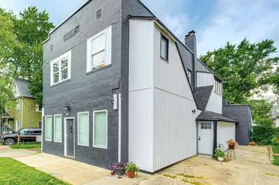 a black and white house with a garage at Walkable Barberton Apartment 9 Mi to Akron! in Barberton
