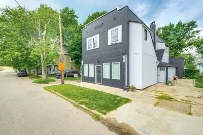 a black and white house on a street at Walkable Barberton Apartment 9 Mi to Akron! in Barberton