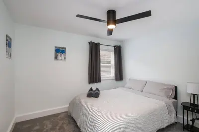 a bedroom with a bed with a ceiling fan at 5th Street Retreat Private Home OSU, Short North in Columbus