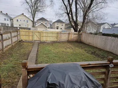 a backyard with a wooden fence and a wooden bench at 5th Street Retreat Private Home OSU, Short North in Columbus