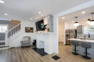 a kitchen and living room with a fireplace and a tv at 5th Street Retreat Private Home OSU, Short North in Columbus