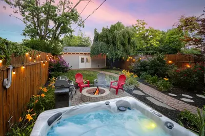 a backyard with a hot tub and a fire pit at Home with Garage, Hot Tub, near OSU & Short North in Columbus