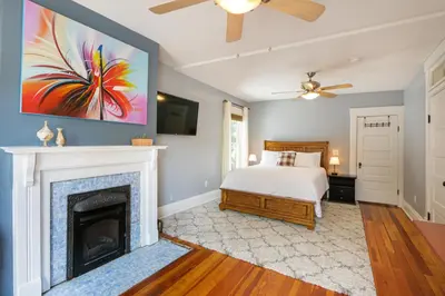 a bedroom with a bed and a fireplace at Home with Garage, Hot Tub, near OSU & Short North in Columbus