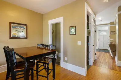 a dining room with a wooden table and chairs at Home with Garage, Hot Tub, near OSU & Short North in Columbus