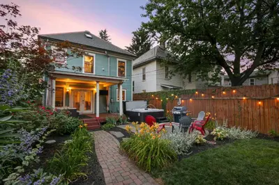 a house with a patio and a fence at Home with Garage, Hot Tub, near OSU & Short North in Columbus