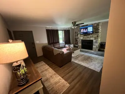 a living room with a couch and a fireplace at Hillside country cabin in Lancaster
