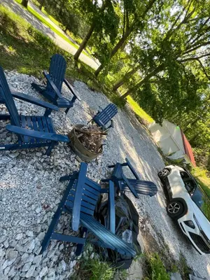 a group of blue chairs and a car on a road at Hillside country cabin in Lancaster